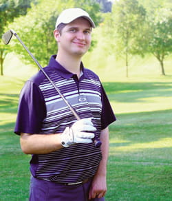Ryan, with golf club over his shoulder.